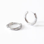 Pair of silver hoop earrings on a white background
