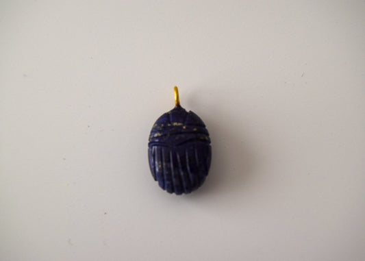 Intricately detailed, this versatile lapis lazuli scarab charm features a delicate scarab design carved from lapis lazuli gemstone, with the pendant ring made of gold plated material, it is  perfect for various jewelry creations like a necklace or earrings, displayed on a neutral background