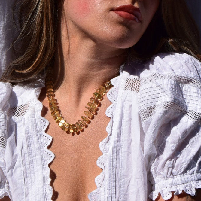 Woman in a white blouse against a white curtain