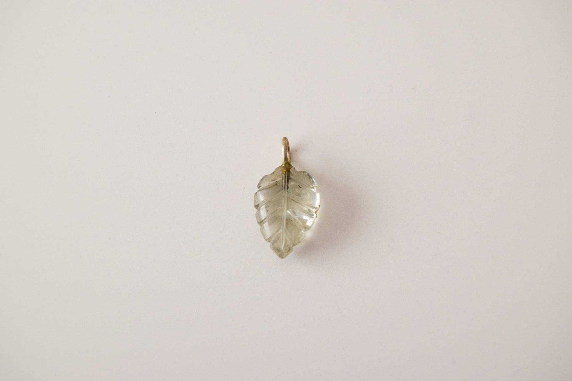 Intricately detailed, this versatile rutilated quartz leaf features a delicate leaf design carved from rose quartz gemstone, it is perfect for various jewelry creations like a necklace or earrings.