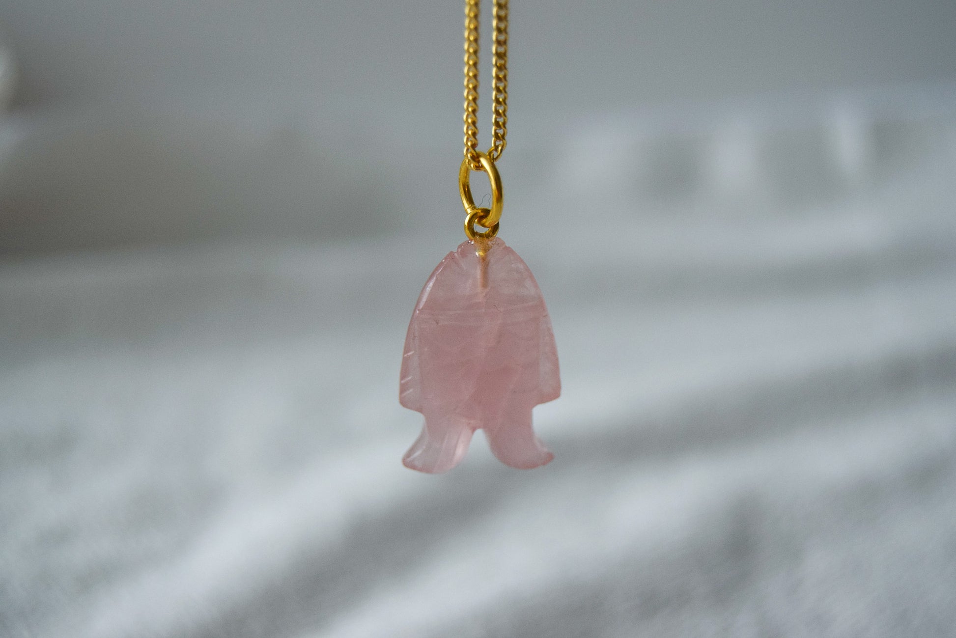 Intricately detailed, this versatile rutilated quartz leaf features a delicate leaf design carved from rose quartz gemstone, it is perfect for various jewelry creations like a necklace or earrings.