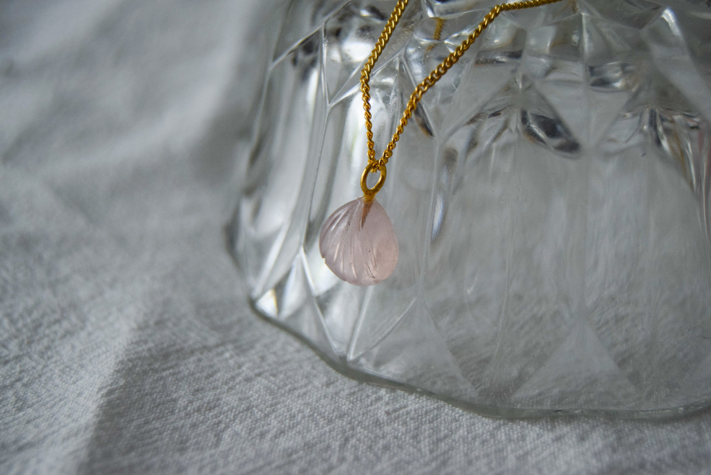 Intricately detailed, this versatile rutilated quartz leaf features a delicate leaf design carved from rose quartz gemstone, it is perfect for various jewelry creations like a necklace or earrings.