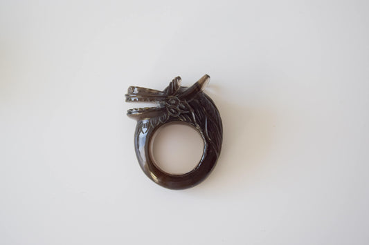 Smokey Quartz stone ring with carved and engraved dragon on a neutral background