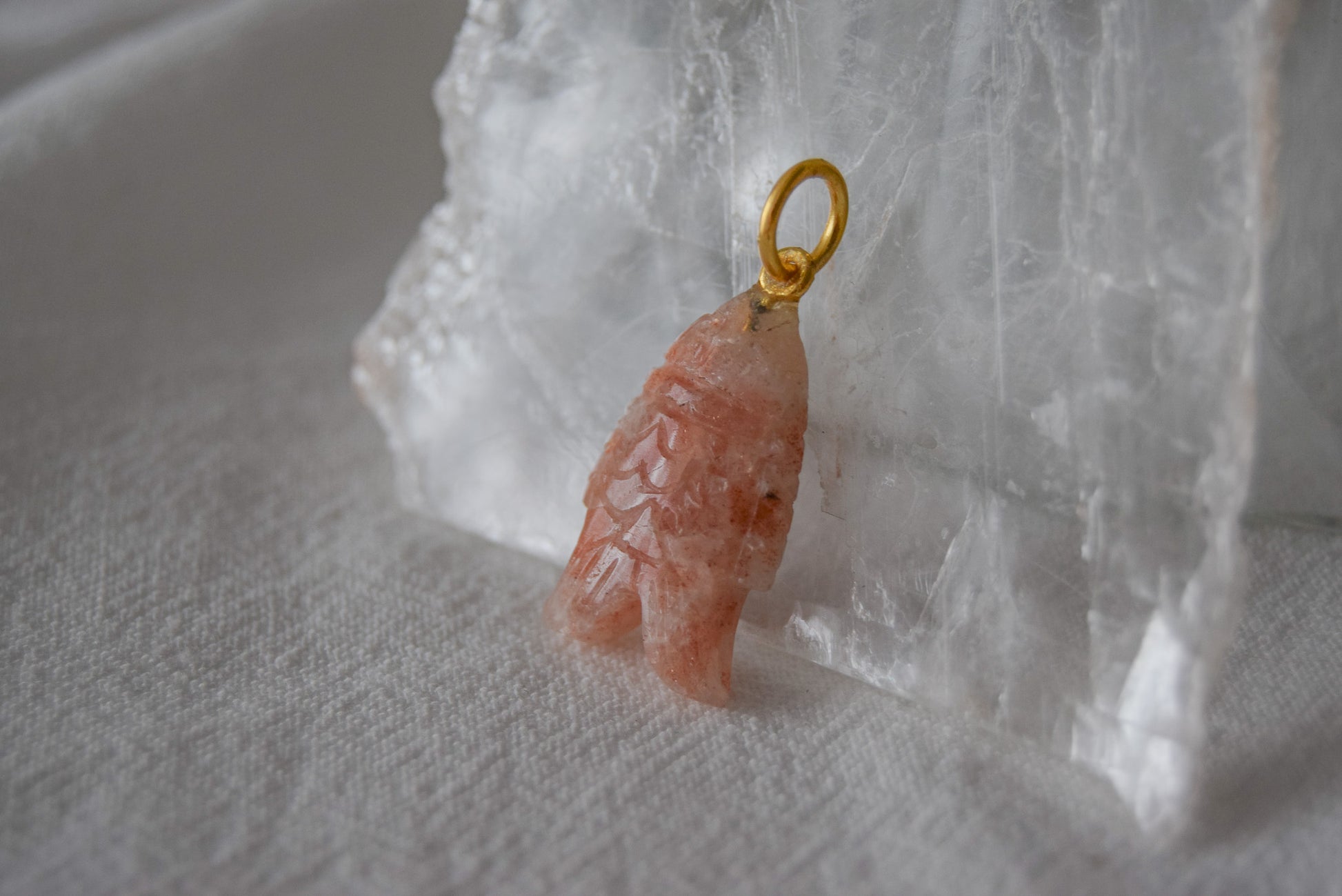 Intricately detailed, this versatile sunstone fish features a delicate fish design carved from sunstone gemstone, it is perfect for various jewelry creations like a necklace or earrings