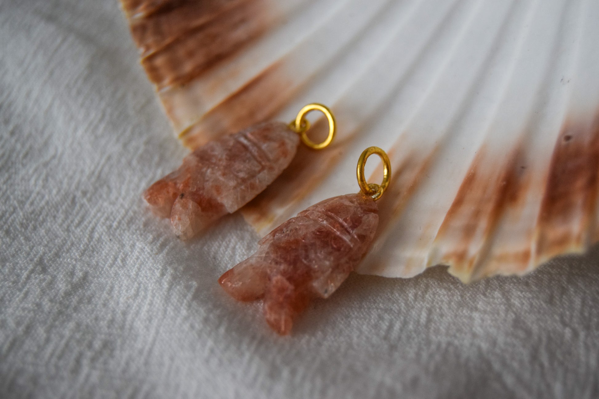 Intricately detailed, this versatile sunstone fish features a delicate fish design carved from sunstone gemstone, it is perfect for various jewelry creations like a necklace or earrings